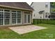 Exterior home view showcasing patio, fenced-in yard, and sunroom at 5656 Cambridge Bay Dr, Charlotte, NC 28269