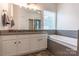 A luxurious bathroom features a large soaking tub and double sinks at 5656 Cambridge Bay Dr, Charlotte, NC 28269