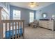 A charming Bedroom with a crib, chair and dresser is shown at 5656 Cambridge Bay Dr, Charlotte, NC 28269