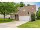 Attractive brick house with a two-car garage, driveway, and landscaped front yard on a pleasant day at 5656 Cambridge Bay Dr, Charlotte, NC 28269