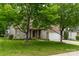 Lovely brick home featuring a well-maintained lawn, a driveway, and mature shade trees on a sunny day at 5656 Cambridge Bay Dr, Charlotte, NC 28269