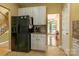 Functional kitchen showcases white cabinets, black appliances, and tile flooring at 5656 Cambridge Bay Dr, Charlotte, NC 28269