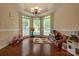 Bright living room features hardwood flooring, large windows, and a playful decor with toys and games at 5656 Cambridge Bay Dr, Charlotte, NC 28269