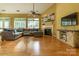 Bright living room featuring hardwood floors, fireplace, and plenty of natural light at 5656 Cambridge Bay Dr, Charlotte, NC 28269