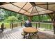 Inviting covered back deck with grilling area and outdoor dining space at 5772 Gettysburg Nw Dr, Concord, NC 28027