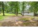 A spacious, tree-filled backyard, perfect for outdoor activities, with a glimpse of a shed at 5772 Gettysburg Nw Dr, Concord, NC 28027