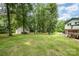 Expansive backyard with mature trees, lush lawn, and charming shed at 5772 Gettysburg Nw Dr, Concord, NC 28027