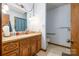 Full bathroom with neutral tile floors and oak cabinets at 5772 Gettysburg Nw Dr, Concord, NC 28027