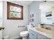 Cozy bathroom features a wood framed window and blue accent wall at 5772 Gettysburg Nw Dr, Concord, NC 28027