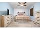Bedroom featuring a large dresser, light colored walls and laminate flooring at 5772 Gettysburg Nw Dr, Concord, NC 28027