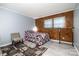 Bedroom with wood wall, gray accent wall, and laminate flooring at 5772 Gettysburg Nw Dr, Concord, NC 28027
