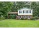 Charming two-story home featuring a brick facade, light green siding, and a well-manicured lawn at 5772 Gettysburg Nw Dr, Concord, NC 28027