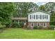 Charming two-story home featuring a brick facade, light green siding, and a well-manicured lawn at 5772 Gettysburg Nw Dr, Concord, NC 28027