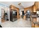 Bright kitchen with stainless steel refrigerator, wood cabinets, marble-look flooring, and modern appliances at 5772 Gettysburg Nw Dr, Concord, NC 28027