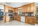 Well-lit kitchen features wood cabinets, stainless steel appliances, and backyard views with a clear layout and design at 5772 Gettysburg Nw Dr, Concord, NC 28027