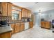 Bright kitchen featuring wood cabinets, stone countertops, tile backsplash, a window and a view of the back yard at 5772 Gettysburg Nw Dr, Concord, NC 28027