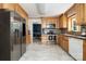 Bright kitchen showcasing stainless steel appliances, wood cabinets, marble-style flooring, and adjacent dining area at 5772 Gettysburg Nw Dr, Concord, NC 28027
