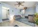 Cozy living room with tile floors, comfortable seating, laundry access, and a staircase to another level at 5772 Gettysburg Nw Dr, Concord, NC 28027