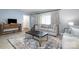 Bright living room with light gray furniture, a stylish rug, and a wooden console table at 5772 Gettysburg Nw Dr, Concord, NC 28027
