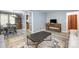 Open living room and dining area with modern decor, a wooden cabinet, and bright lighting at 5772 Gettysburg Nw Dr, Concord, NC 28027