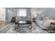 Inviting living room featuring a gray sofa set, decorative rug, and plenty of natural light at 5772 Gettysburg Nw Dr, Concord, NC 28027