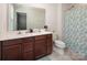 Bright bathroom features a double sink vanity with granite countertops, a toilet, and a shower with leafy patterned curtains at 5812 Camp Sw Ct, Concord, NC 28025
