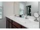 Bright bathroom features a double sink vanity with granite countertops and a large mirror providing a sense of spaciousness at 5812 Camp Sw Ct, Concord, NC 28025