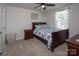 Bedroom displays a wooden bed frame, nightstand, and woven laundry hamper on neutral carpet under a ceiling fan at 5812 Camp Sw Ct, Concord, NC 28025