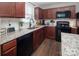 Well-lit kitchen featuring granite counters, stainless steel sink, and wooden cabinets at 5812 Camp Sw Ct, Concord, NC 28025