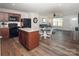 Modern kitchen and open-concept living area with hardwood floors and an eat-in island at 5812 Camp Sw Ct, Concord, NC 28025