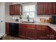 Bright kitchen with granite counters, white subway tile backsplash, and black dishwasher at 5812 Camp Sw Ct, Concord, NC 28025