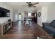 Inviting living room featuring hardwood floors, a ceiling fan, and an open layout leading to the kitchen at 5812 Camp Sw Ct, Concord, NC 28025