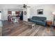 Open-concept living room featuring hardwood floors, a ceiling fan, and a combined kitchen-dining area at 5812 Camp Sw Ct, Concord, NC 28025