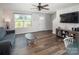 Bright living room with hardwood floors, large windows, and ample natural light creating an inviting space at 5812 Camp Sw Ct, Concord, NC 28025