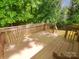 Inviting wooden back deck area with a wood railing and surrounding greenery at 6041 Misty Way Ln, Charlotte, NC 28212