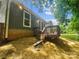 Cozy home exterior featuring a wooden deck with steps down to the yard and trees, providing a relaxing outdoor space at 6041 Misty Way Ln, Charlotte, NC 28212