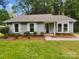 Charming single-story home with light blue siding, white trim, and well-manicured landscaping at 6041 Misty Way Ln, Charlotte, NC 28212