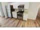 Updated kitchen features stainless steel appliances, white cabinets, and granite countertops at 6041 Misty Way Ln, Charlotte, NC 28212