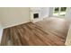 Bright living room showcases beautiful floors, a white fireplace, and lots of light at 6041 Misty Way Ln, Charlotte, NC 28212