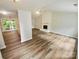 Spacious living room featuring wood flooring and fireplace at 6041 Misty Way Ln, Charlotte, NC 28212
