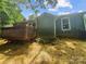 View of a charming home showcasing a deck and siding, nestled in a wooded setting at 6041 Misty Way Ln, Charlotte, NC 28212
