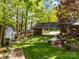 Lush backyard featuring a charming shed and covered driveway at 617 Peace Haven Rd, Kannapolis, NC 28083
