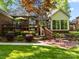 Gorgeous backyard with a wooden deck, brick patio, and serene green space surrounded by trees at 617 Peace Haven Rd, Kannapolis, NC 28083