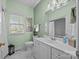 A bathroom with a vanity, toilet, and white hexagon tile flooring at 617 Peace Haven Rd, Kannapolis, NC 28083