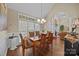 Bright dining room with a large table, chandelier, and stained glass window accents at 617 Peace Haven Rd, Kannapolis, NC 28083