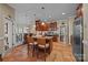 Bright kitchen with an island, terracotta-colored tile flooring, stainless appliances, and wooden cabinets at 617 Peace Haven Rd, Kannapolis, NC 28083