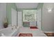 A bathroom features a vanity, a jetted tub, a makeup vanity with lights, a walk in shower and lots of storage at 617 Peace Haven Rd, Kannapolis, NC 28083