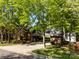 View of the rear of the house showing a covered driveway and mature trees at 617 Peace Haven Rd, Kannapolis, NC 28083