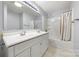 Bathroom with double sink vanity, large mirror, tub and shower combination with white shower curtain at 64 Timberidge Dr, Lake Wylie, SC 29710