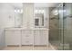 Bright bathroom featuring double vanity, ample storage, and a glass enclosed shower with tiled walls at 64 Timberidge Dr, Lake Wylie, SC 29710